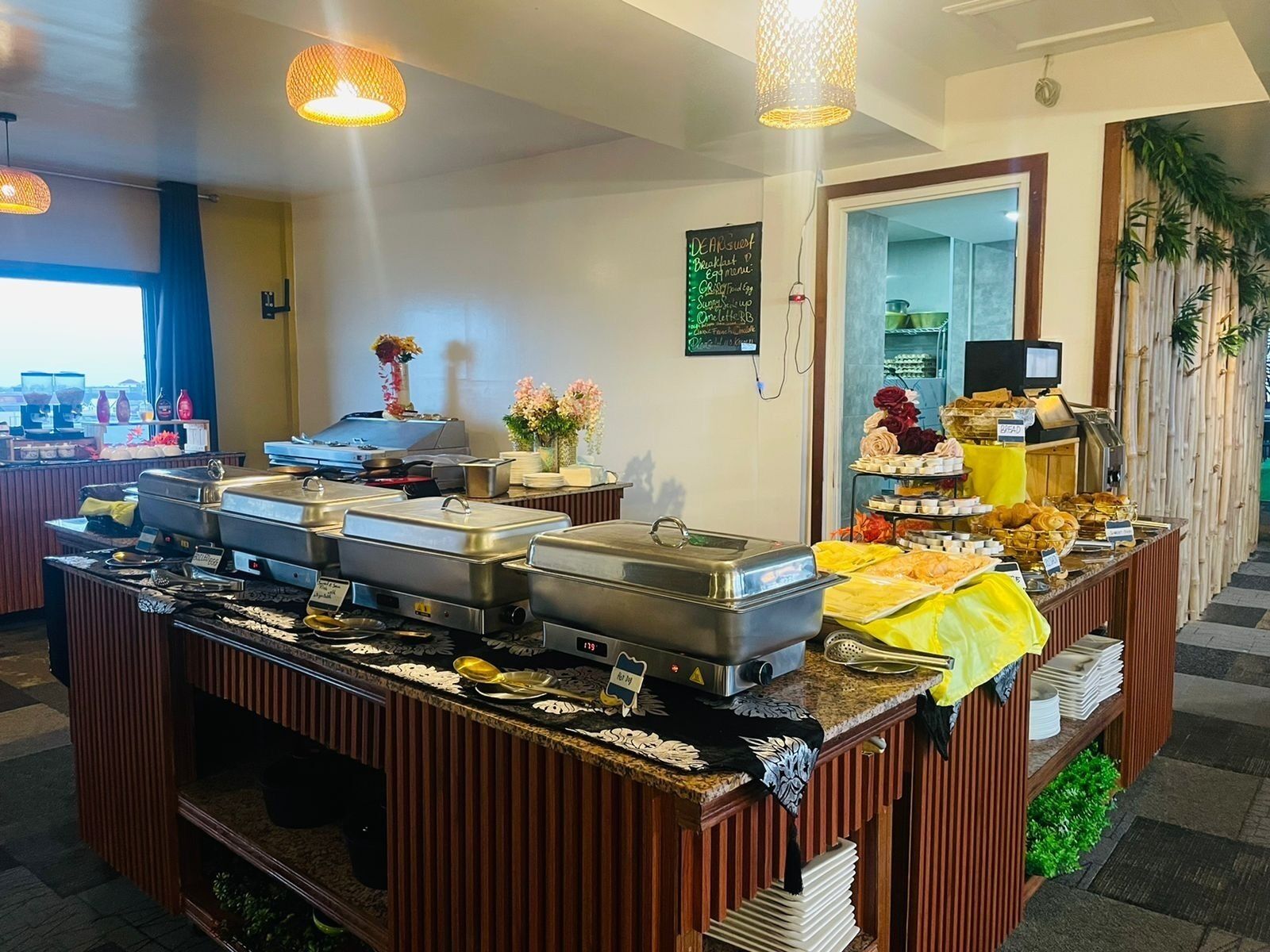 A buffet setup with various food stations and a coffee machine.