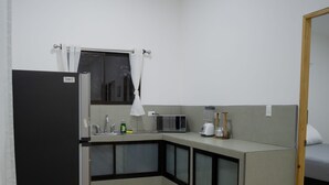 A compact kitchen with a refrigerator, microwave, and sink. - Apartment Pinilla With 2 Room, Kitch, a/c (Pinilla)