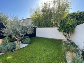Stroll through a serene garden area surrounded by a variety of plants and trees.