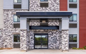 A modern building with a stone facade, a black entrance, and a logo that reads "my PLACE". - My Place Hotel-Tucson North/Marana/Cortaro, AZ (Tucson)