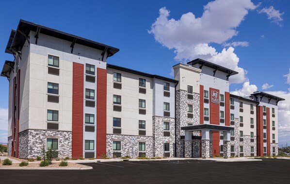A multi-story hotel with a modern design, featuring a mix of red and white exterior walls, stone accents, and a covered entrance area. - My Place Hotel-Tucson North/Marana/Cortaro, AZ (Tucson)