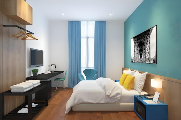 A modern hotel room with a bed, desk, chair, and a painting on the wall. - S Hotel (Johor Bahru)