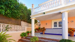 A covered outdoor area with a checkered floor, potted plants, and a white railing. - Villa Nerja Angeles - Three Bedroom Villa, Sleeps 6 (Nerja)