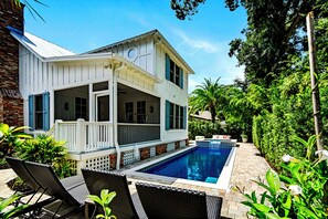 A two-story house with a covered patio and a swimming pool. - Beautiful 4 bed, 3.5 bath home w/pool and hot tub. Walk to Village area! (Saint Simons Island)
