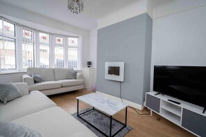 Relax in this stylish living room with a sofa, flat-screen TV, and coffee table.