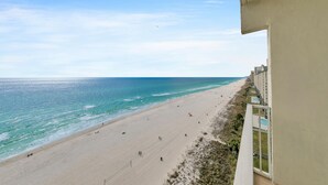A beach view from a balcony overlooking a sandy beach with a clear sky. - 🌊Beachfront Complex-2BR Shores of Panama 1202🌊 (Panama City Beach)