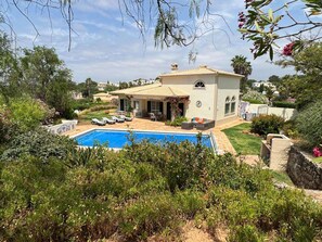A Mediterranean-style villa with a swimming pool, outdoor seating, and lush landscaping. - Vista da Montanha - Three Bedroom Villa, Sleeps 6 (Carvoeiro)