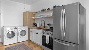 A modern kitchen with stainless steel appliances, wooden cabinets, and a built-in oven. - Lawless: A Boutique Basecamp in Rico (Rico)
