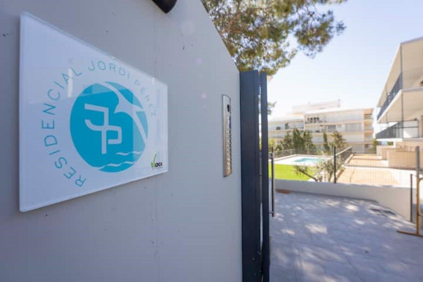 Ein Wohnkomplex, der mit einem Schild als Teil des Projekts „JORDI PER“ gekennzeichnet ist.