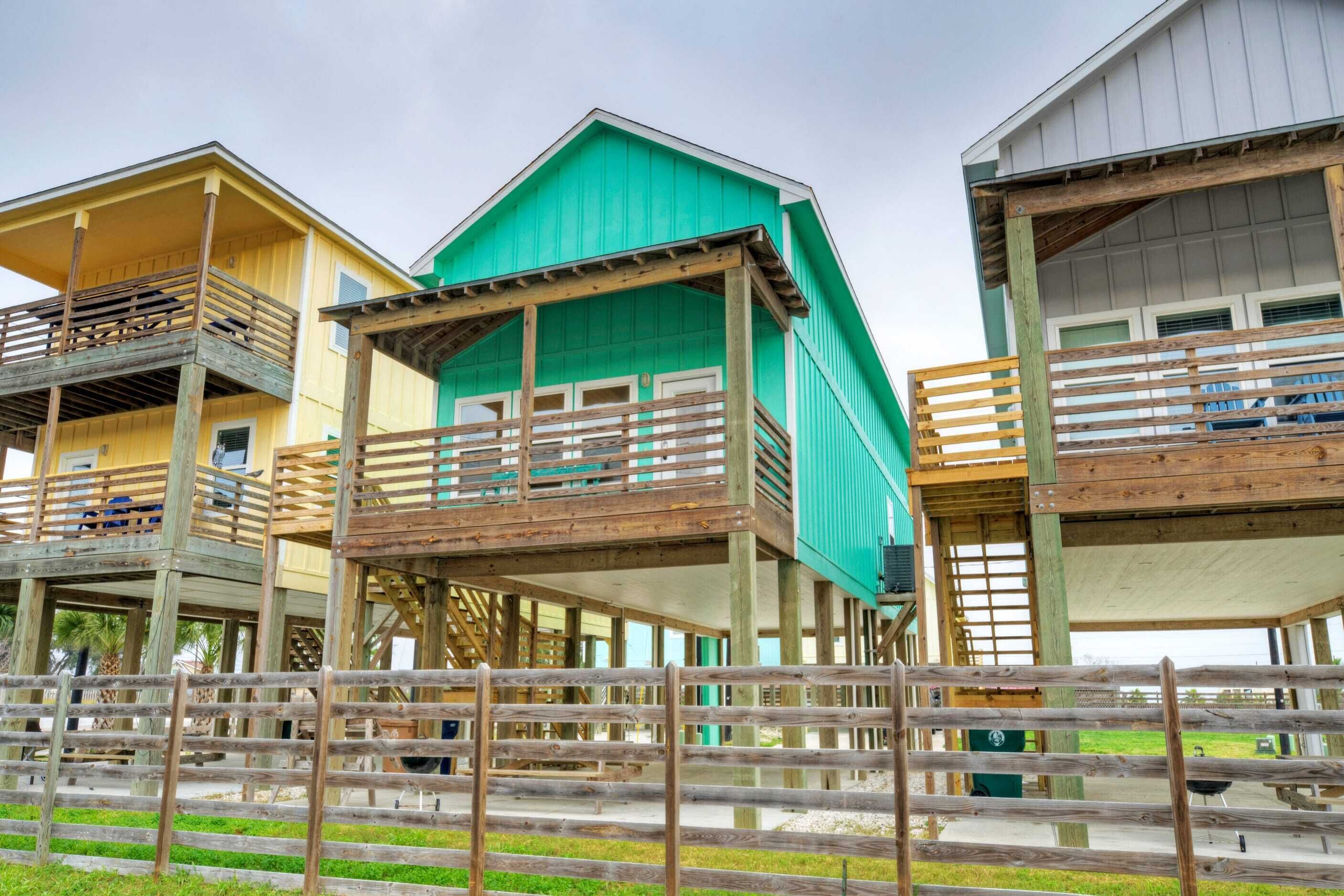 A series of elevated wooden structures with balconies, likely part of a resort or vacation property.