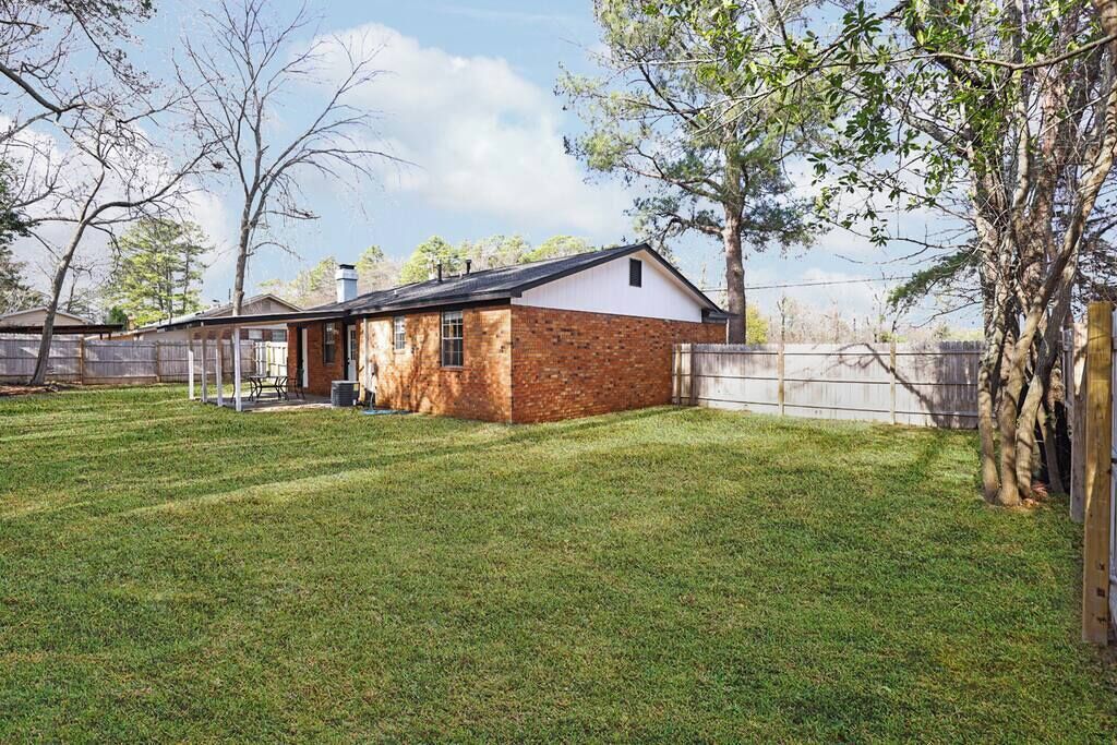 A single-story house with a brick exterior and a white front.