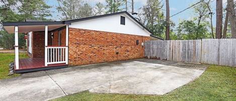 A single-story house with a brick exterior and a covered porch.
