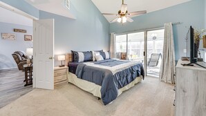 A bedroom with a bed, a desk, a chair, a ceiling fan, and a window. - Updated Branson Condo w/ Lake Taneycomo Views! (Branson)