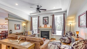 A cozy living room with a fireplace, leather sofas, and a dining area with a wooden table. - Bayfield Retreat, 9 Mi to Vallecito Reservoir! (Bayfield)