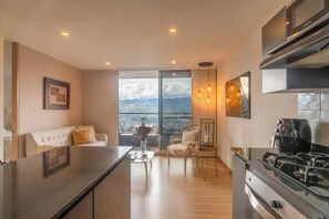 Enjoy meals in the kitchen with a gas stove and dining area featuring a sofa and small table.