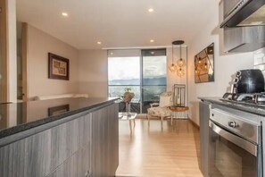 Enjoy cooking in this well-equipped kitchen with a large window offering a view of the outdoors.