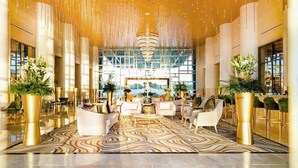 A spacious lobby with a modern chandelier, plush seating, and large windows offering a view. - VIP luxury for Christmas at Cancun's 5 diamond resort!  (Cancun)