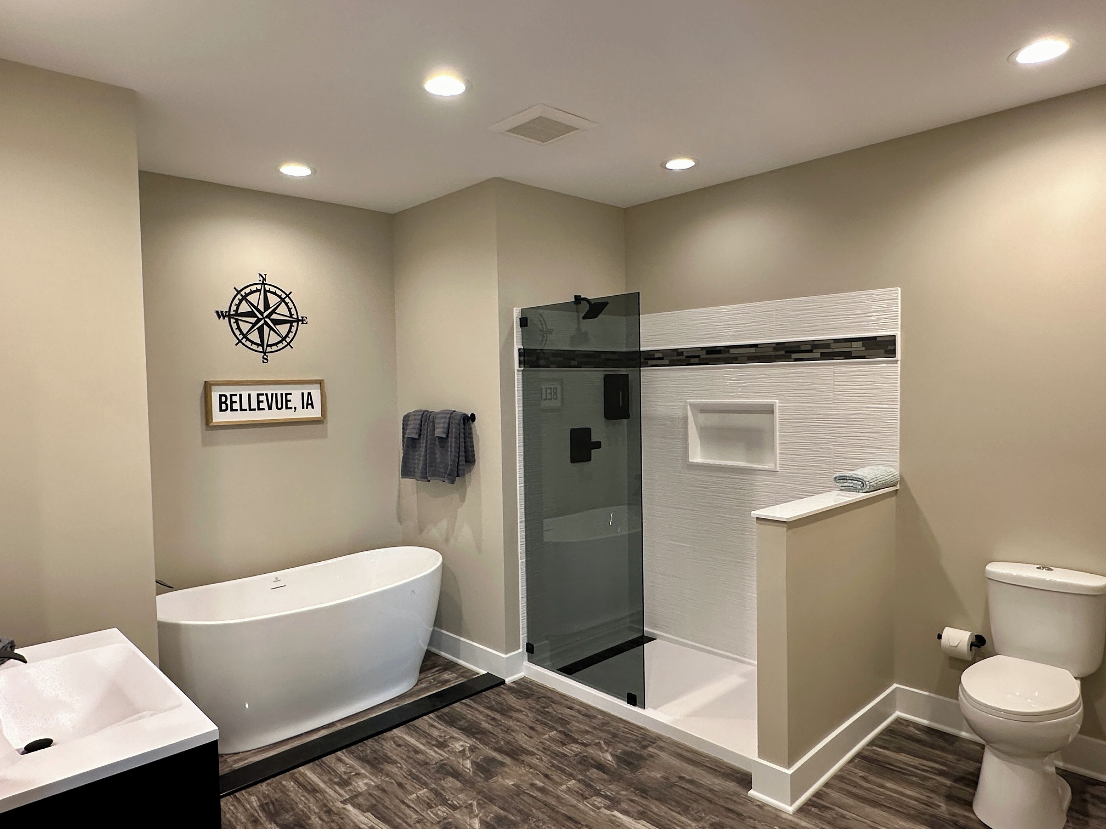 A modern bathroom with a freestanding bathtub, a glass-enclosed shower, and a toilet.