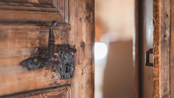 A wooden door with a metal latch and a keyhole.
