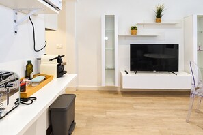 A modern kitchen with a built-in oven, a coffee machine, and a trash bin. - Cubo's Apartment Front Line Beach Fuengirola / First line of beach / Air conditioning (Fuengirola)
