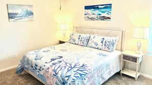 A bedroom with a bed, a ceiling fan, two wall-mounted lamps, and two paintings. - Near Airport & Beach Fully Fenced House (Jacksonville)