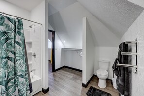 A modern bathroom with a shower, toilet, and bathtub. - The Cardinal: The  Downtown Dream Sleeps 13! (Webb City)