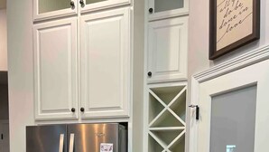 A kitchen with white cabinetry, a stainless steel refrigerator, a granite countertop, and a door with a frosted glass panel. - Main House Listing 3BD/2BA

 (Edinburg)