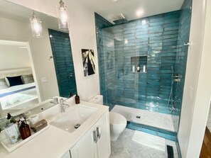 A modern bathroom with a glass shower enclosure, a white sink, and a toilet. - Calistoga Wine Ranch (Calistoga)
