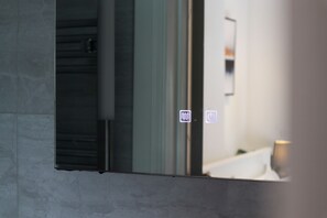 A bathroom with a mirror, a toilet, and a sink. - Our split level Duplex is setup to give you an experience of home away from home (london)