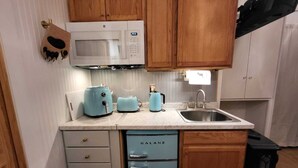 A compact kitchen with a microwave, toaster, kettle, and a small refrigerator. - A Private City, Cabin-feel Studio for 1 Person (Fairbanks)