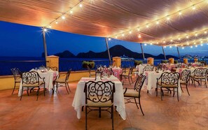 Enjoy al fresco dining with a view of the surrounding landscape and serene body of water.