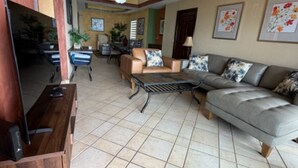 A living room with a television, sofa, and dining area. -  Welcome to Rocky Point Mexico. Enjoy the most beautiful Beach in Rocky Point . (Puerto Peñasco)