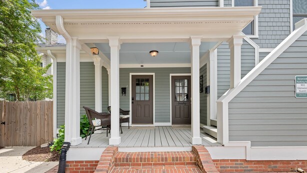 A house with a covered porch, a brick entrance, and a sign indicating reserved parking for guests. - Charming Studio Apt in Downtown Raleigh-Walkable location! (Raleigh)