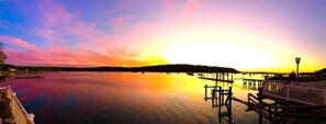 Enjoy serene waterfront views from the pier, where the calm water meets the sky.
