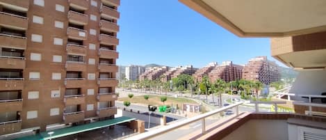 A high-rise building with multiple balconies and a clear view of the surrounding urban landscape.