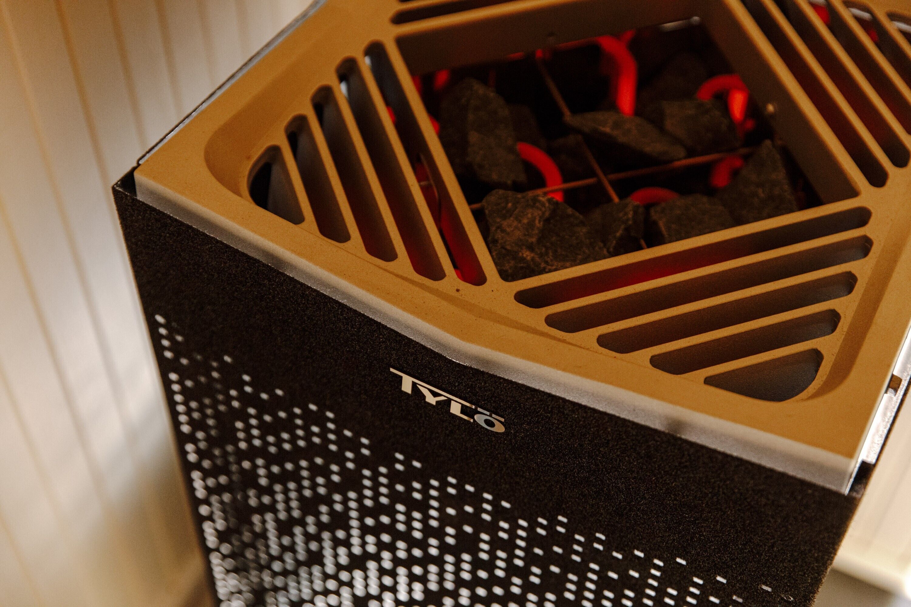 A black box with a ventilation grill and the brand name 'TYLO' on it.