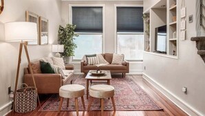 A living room with a sofa, two armchairs, a coffee table, and a floor lamp. - THE SKYSCRAPER IN HEART OF COLUMBUS (Columbus)