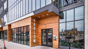 A modern building with a wooden facade and large windows. - Shades of Blue Elegant Suite l Free Parking + Gym (Columbus)