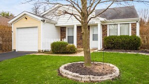A single-story house with a garage, a front yard with a tree, and a brick exterior. - DUBLIN GETAWAY - NEAR COLUMBUS! (Dublin)