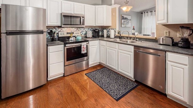A modern kitchen with white cabinets, stainless steel appliances, a microwave, oven, and a dishwasher. - DUBLIN GETAWAY - NEAR COLUMBUS! (Dublin)