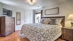 A bedroom with a bed, dresser, TV, and a framed quote on the wall. - Moab Oasis among the Redrocks! (Moab)