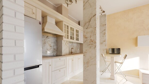 Una cocina moderna con armarios blancos, protector contra salpicaduras de mármol y microondas empotrado.