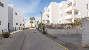 A modern, white building with balconies and a paved street. - PARAISO COSTERO  - Cosy flat with shared pool (Conil de la Frontera)
