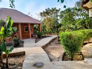 Relax in a serene outdoor space surrounded by lush greenery and a tranquil atmosphere.