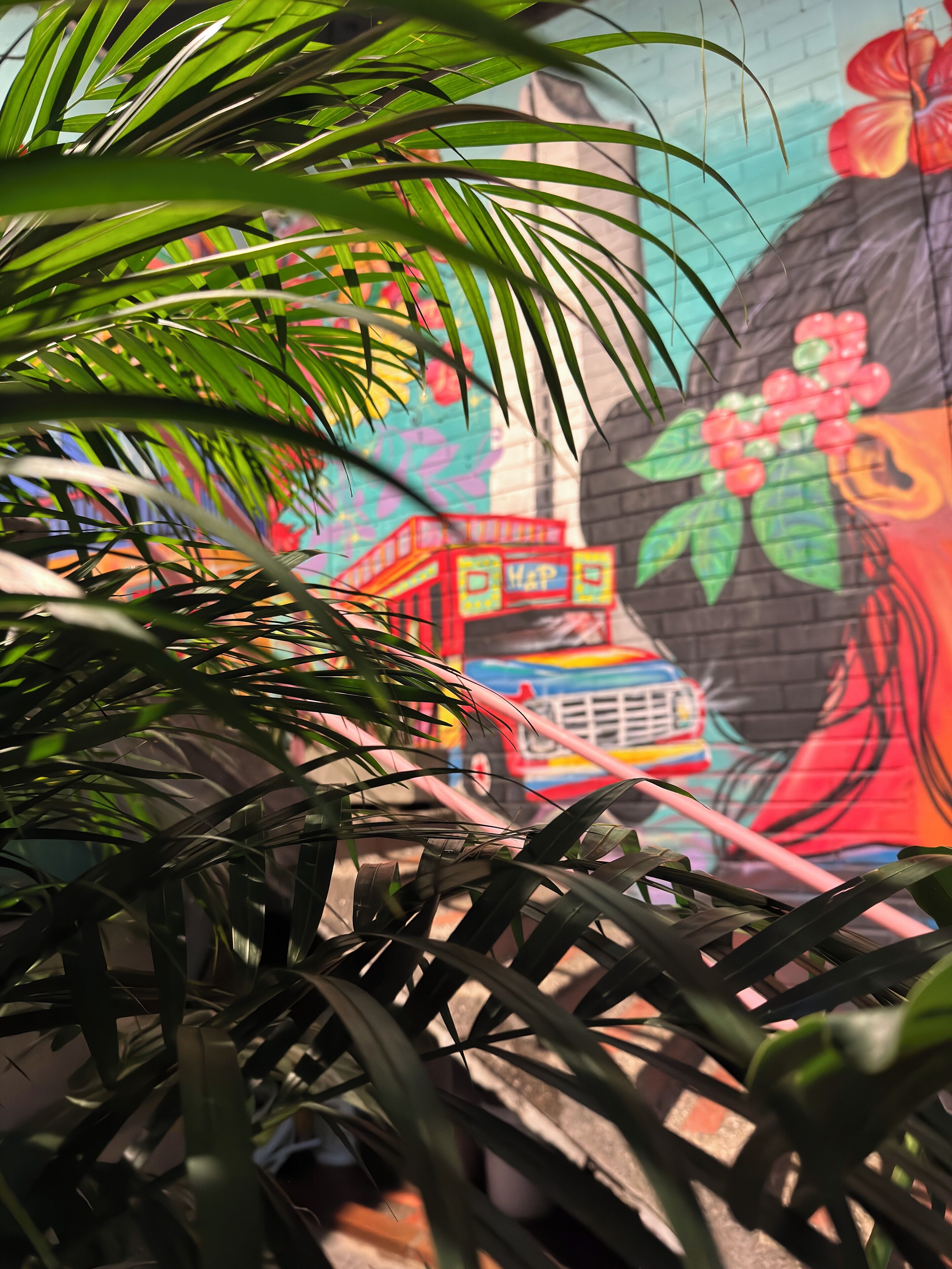 A vibrant mural with a colorful bus and a large flower.