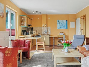 A compact living space with a kitchen, dining area, and seating.