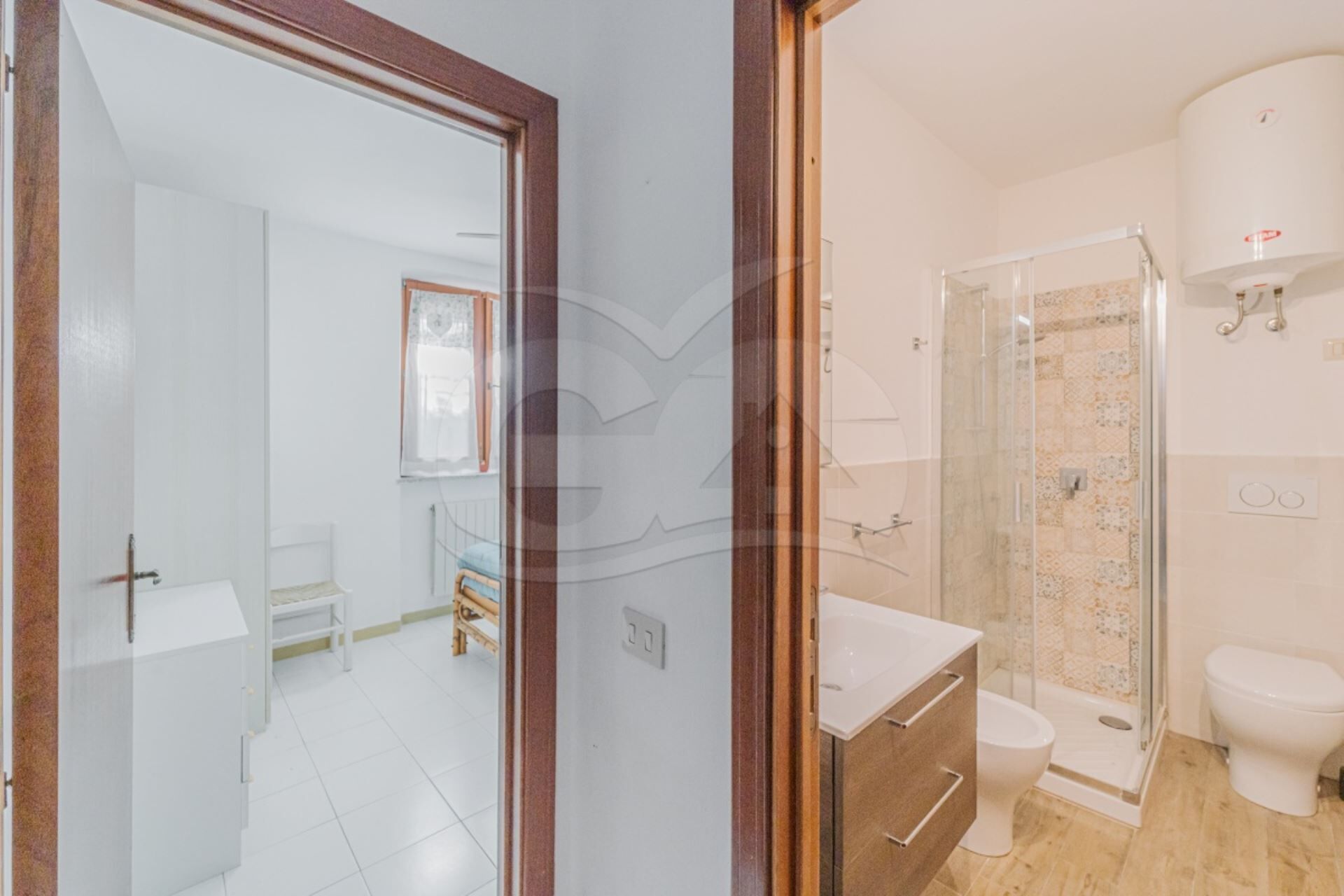 A modern bathroom with a glass shower enclosure, a white toilet, and a vanity with a mirror.