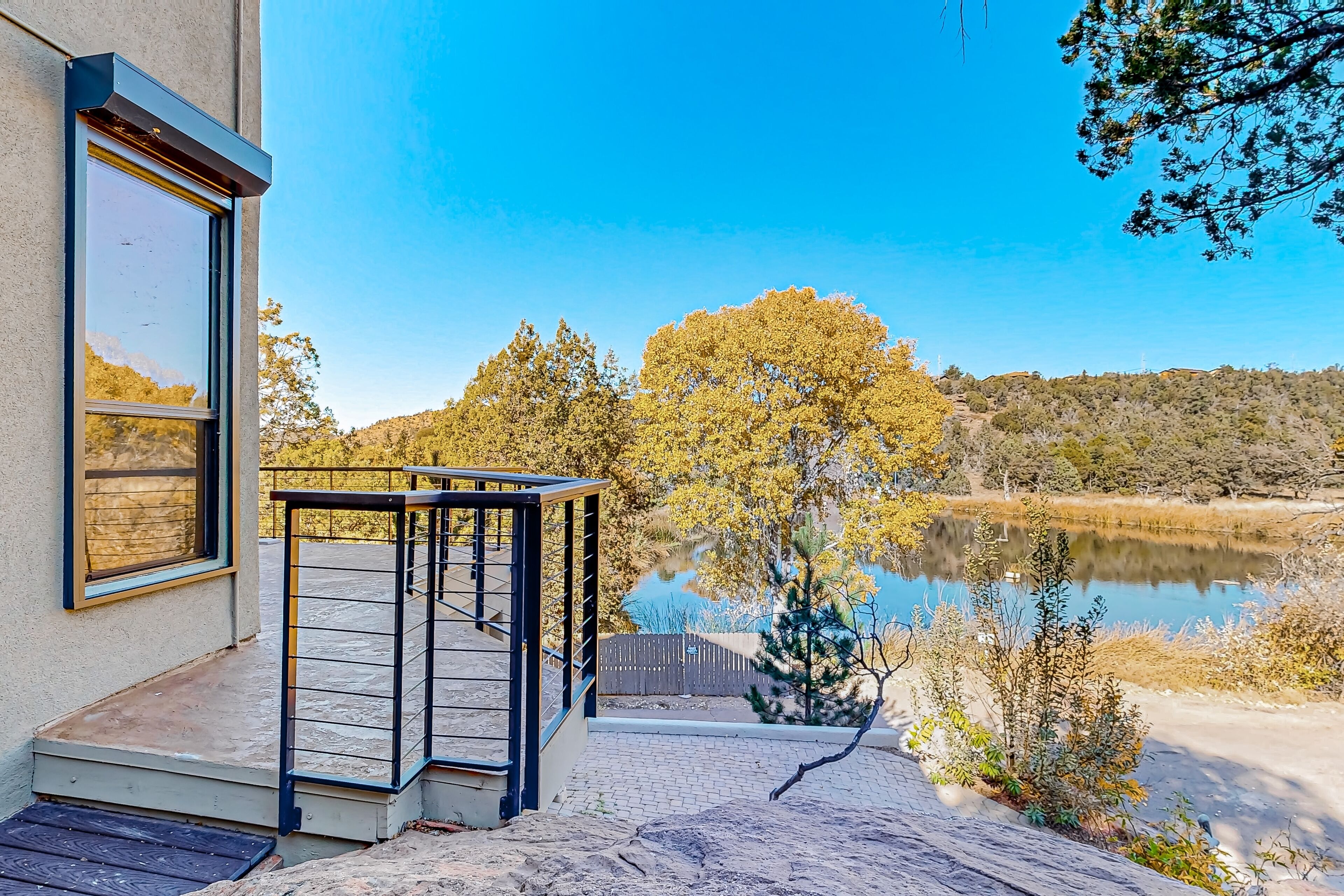 Water- & mountain-view home with patio, grill, jetted tub, washer/dryer, & AC