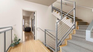 A modern staircase with metal railings and carpeted steps leading to an upper floor. - Alley-By Loft: Smack Dab in the Middle of Ashland!  Steps from Theaters & Lithia (Ashland)