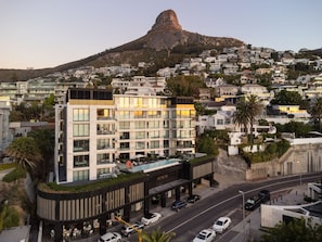 A modern hotel with a rooftop pool, surrounded by a hilly residential area. - Aurum 501 (Cape Town)